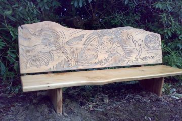Wooden carved bench engraved with Cormorant artwork