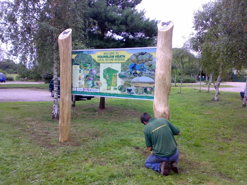 man installing large welcome sign