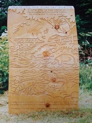 wooden board with wildlife images carved into it